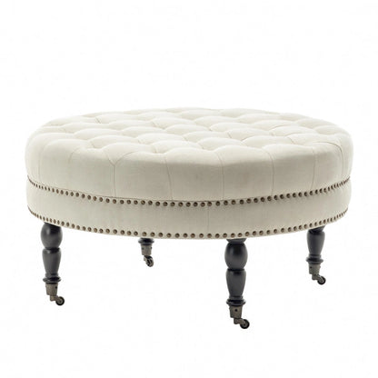 Porthos Home Indy Fabric Round Cocktail Ottoman with Rubberwood Legs and Wheels